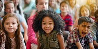 Diverse group of children sitting together, smiling and engaged. Kids of various ethnicities, including a Black girl and a boy yawning, enjoying a group activity. Diverse children, group in school.