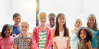 A diverse group of smiling children standing together. The group includes boys and girls of various ethnicities, all looking happy and cheerful. Diverse happy chilren of various ethnicitie.