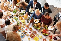 A diverse group of people enjoying a buffet with various dishes. The buffet features salads, seafood, and desserts. People gather around the buffet table. Diverse people enjoying a buffet at a hotel.