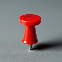 A red push pin stationery accessory bulletin.