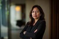 Hispanic business woman in her 40s standing in the office professional executive portrait.