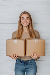 Woman carrying boxes and a cardboard box background package white.