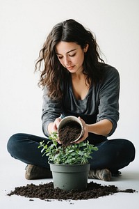 Woman plant soil gardening.