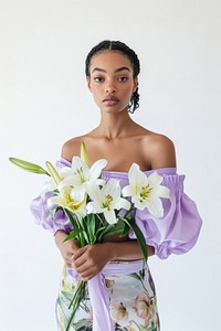 Woman in a pastel purple top and floral skirt background portrait bouquet.