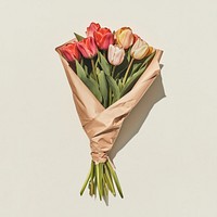 A bouquet of colorful tulips wrapped in kraft paper flowers petals arrangement.