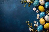 Colorful Easter eggs on a dark blue background celebration flowers holiday.