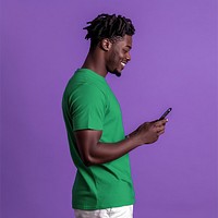 An isolated black man wearing green shirt playing his phone with smile photography background person.