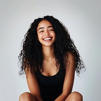 Woman with long curly hair portrait happy laughing.