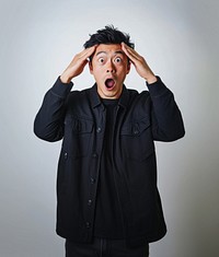 Asian man with shocked face surprised portrait clothing.