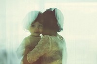 Mother hugging kid photo photography reflection.