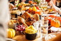 A festive Thanksgiving dinner featuring a beautifully roasted turkey, vibrant pumpkins, and colorful side dishes. The Thanksgiving table is adorned with delicious food, perfect for a joyful Thanksgiving celebration.