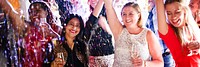 Group of diverse women celebrating at a party, smiling and raising glasses. Festive with confetti and joy. Women enjoying a lively celebration. Mature people celebrating at festive holiday party.