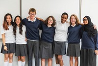 Group of diverse students in school uniforms, smiling and standing together. School uniforms, diverse group, smiling students, happy teens, unity in diversity. Diverse international school students.