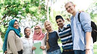 Diverse group of young adults smiling outdoors. Friends from various backgrounds, enjoying time together. Happy, diverse, and youthful group bonding. Diverse young friends in school park.