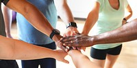 Diverse group of people joining hands in a circle, symbolizing teamwork and unity. Hands of different ethnicities, showing collaboration and support. People joining hands, diversity, teamwork, unity.