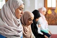 Women in hijabs praying together, showing focus and unity. Diverse group of women in hijabs, reflecting faith and community in prayer. Peaceful and serene atmosphere. Muslim women praying together