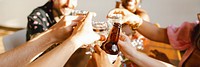 Group of people clinking glasses in celebratory toast. Diverse hands holding drinks, creating festive atmosphere. Cheers and celebration in social gathering. Diverse friends celebrate birthday party.