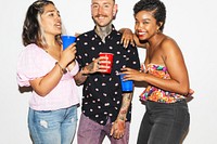 Three people enjoying a party, holding drinks, smiling. Casual party vibe, diverse group, colorful outfits, cheerful atmosphere, social gathering. Friends at college dorm party.