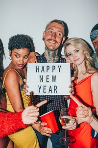 Group celebrating New Year with diverse friends. Happy New Year sign held by friends. Diverse group, New Year joy, friends celebrating together. Friends at new year party.