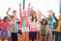 Group of diverse children having fun in a library. Kids smiling, raising hands, and enjoying their time. Happy children, diverse group, library fun. Cute little diverse kids, arms raised.