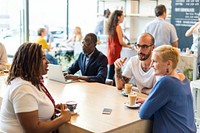 Diverse group in a cafe, chatting and enjoying coffee. People of various ethnicities and genders, socializing and working in a lively cafe setting. Diverse people at a coffee shop.