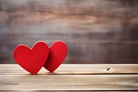 Two red wooden hearts valentine's symbol table.