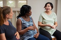 Three pregnant women sitting and talking in a casual setting, sharing experiences and advice. Diverse group engaged in a supportive discussion. Women pregnancy group advise concept.