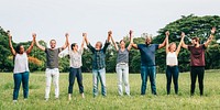 Diverse group of people holding hands in a park, unity and friendship. Men and women of diverse ethnicities enjoying outdoors together. Diverse people friends in a green park, outdoor activity.