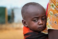 A woman holds a young child while they wait to enter a free medical clinic run by Ugandan and Burundian military personnel serving with the African Union Mission in Somalia (AMISOM) in Baidoa, the capital of Bay and Bakool region in central Somalia.