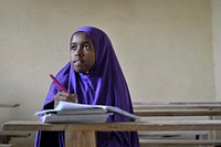 A Somali girl writes in her excercise book during class at as school run by the Abdi Hawa Center in the Afgoye corridor on September 25.