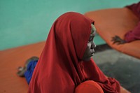 A woman sits on a bed with her sick child at a hospital run by Dr. Hawa in the Afgoye corridor of Somalia on September 25.