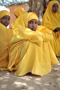 Young girls watch a football game being played outside of their school during breaktime at a center run by Dr. Hawa in the Afgoye corridor, Somalia, on September 25.