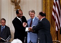 Triple handshake with Carter, Sadat, and Begin in the East Room, September 17, 1978Photo courtesy of Jimmy Carter Library. Original public domain image from Flickr