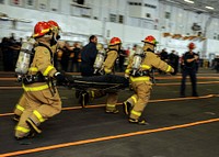 U.S. Sailors compete in a firefighting relay event as part of a damage control Olympics aboard the aircraft carrier USS Theodore Roosevelt (CVN 71) Nov. 2, 2013, in the Atlantic Ocean.