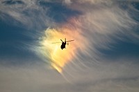 A U.S. Coast Guard HH-65C Dolphin rescue helicopter from Coast Guard Air Station Atlantic City flies in front of a circumhorizontal arc, an atmospheric phenomenon sometimes called a &quot;fire rainbow&quot; on Nov. 6 at Atlantic City International Aiport, N.J. The circumhorizontal arc is formed by plate-shaped ice crystals in high level cirrus clouds.