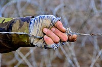 A Czech soldier with Engineer Company, 72nd Mechanized Battalion grabs barbed wire during a European rotational force exercise at the Joint Multinational Readiness Center (JMRC) in Hohenfels, Germany, Nov. 11, 2013, during JMRC rotation 14-01A.