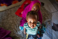 Portrait of Ifrah Abdulle and her daughter Nasri in their shelter at Walala Biyotey IDP. Ifrah underwent FGM at the age of 8 and she suffered an infection. AU UN IST PHOTO / David Mutua. Original public domain image from Flickr