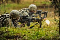 A U.S. Soldier assigned to Alpha Company, 1st Battalion, 503rd Infantry Regiment, 173rd Airborne Brigade Combat Team provides suppressive fire with an M249 light machine gun during movement to contact training at the Grafenwoehr Training Area in Germany March 18, 2014.