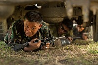 Philippine and U.S. special operations forces (SOF) soldiers low-crawl under multiple vehicles during the 3rd annual SOF Challenge at Fort Magsaysay, Philippines, May 3, 2014, prior to exercise Balikatan 2014.