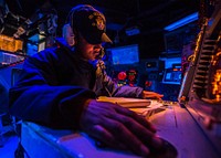 U.S. Navy Operations Specialist 2nd Class Paul Davis mans a watch station in the combat information center aboard the guided missile cruiser USS Vella Gulf (CG 72) in the Mediterranean Sea May 8, 2014.