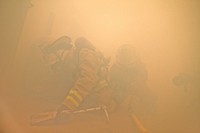 U.S. Air Force fire protection specialists from the New Jersey Air National Guard's 177th Fighter Wing perform a search in a smoke-filled room during a simulated rescue at the Federal Air Marshal Training Center shoot house on March 11, 2014.