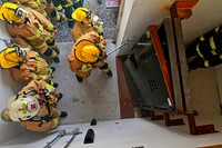 A U.S. Air Force fire protection specialist from the New Jersey Air National Guard's 177th Fighter Wing uses a Halligan bar to breach a door during an exercise at the Federal Air Marshal Training Center shoot house on March 11, 2014.