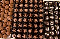 Candy signature truffle sits next to other truffles in a display case to be sold in Baltimore. Original public domain image from Flickr