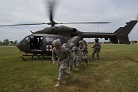 U.S. Soldiers with the 1077th Ground Ambulance Company, Kansas Army National Guard clear the area after loading a patient into a UH-72 Lakota helicopter assigned to Delta Company, 1st Battalion, 376th Aviation Regiment, Nebraska National Guard at Crisis City in Salina, Kan., Aug. 5, 2014, during Vigilant Guard 2014.