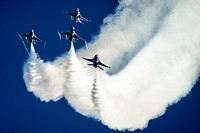 U.S. Air Force pilots with the Thunderbirds perform an arrowhead loop in F-16 Fighting Falcon aircraft during the Wings and Waves Air Show in Daytona Beach, Fla., Oct. 12, 2014.