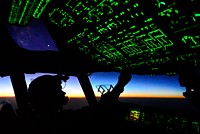 U.S. Air Force Capt. Erica Stooksbury, a C-17 Globemaster III aircraft pilot with the 816th Expeditionary Airlift Squadron, adjusts the cockpit lighting controls in a C-17 over Iraq Aug. 30, 2014, after a humanitarian airdrop mission over Amirli, Iraq. Two C-17s dropped 79 container delivery system bundles of fresh drinking water, or 7,513 gallons.