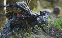 U.S. Air Force Staff Sgt. Lucas Wacker provides security with an M240B machine gun during a training event for the U.S. Army Alaska's Warrior Leader Course on Joint Base Elmendorf-Richardson, May 16, 2014.