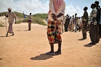 A Somali elder stands with his prayer beads during a demonstration by a local militia, formed in order to provide security for the town of Marka, Somalia, on April 30. AU UN IST PHOTO / Tobin Jones. Original public domain image from Flickr