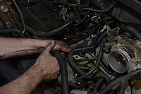 U.S. Air Force Tech. Sgt. Michael Lauterbach, a Sumter, S.C. native, now a heavy mobile equipment mechanic assigned to the 169th Logistics Readiness Squadron on McEntire Joint National Guard Base, S.C., replaces a fuel injector on a government operated Ford F150 April 30, 2014.