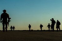 U.S. Soldiers with the 20th Special Forces Group walk on a flight line in Gulfport, Miss., May 5, 2014, during Emerald Warrior 2014.